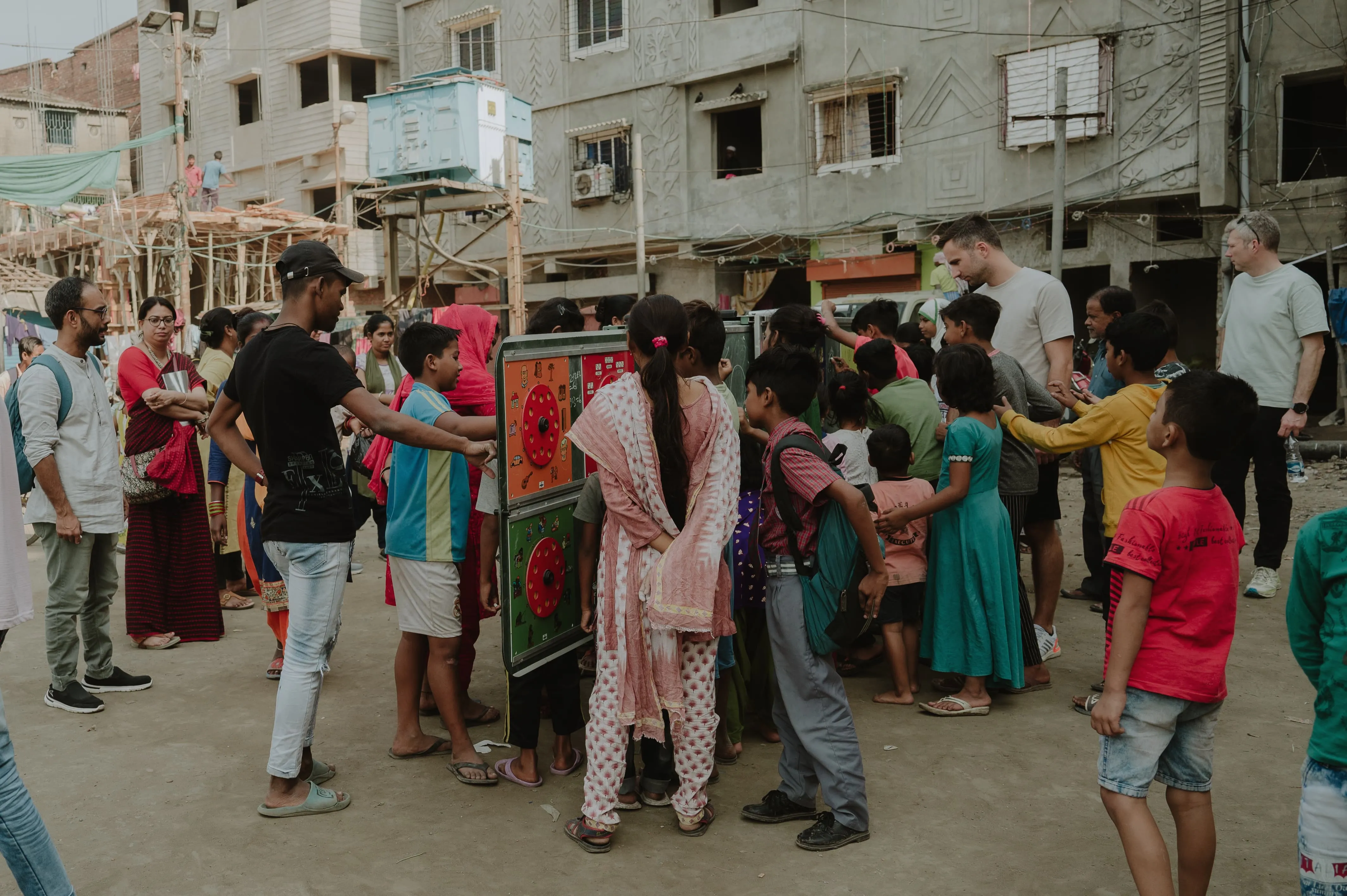 Kids gathering around Tomorrowland Foundation Mobile School